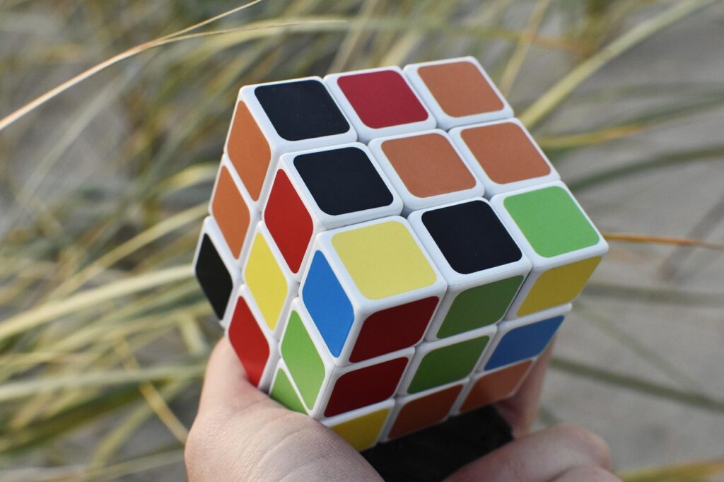 rubik cube, hand, outside, puzzle, game, colors, concentration, cube, solving, toy, skill, mind-breaker, pastime, patience, intelligence