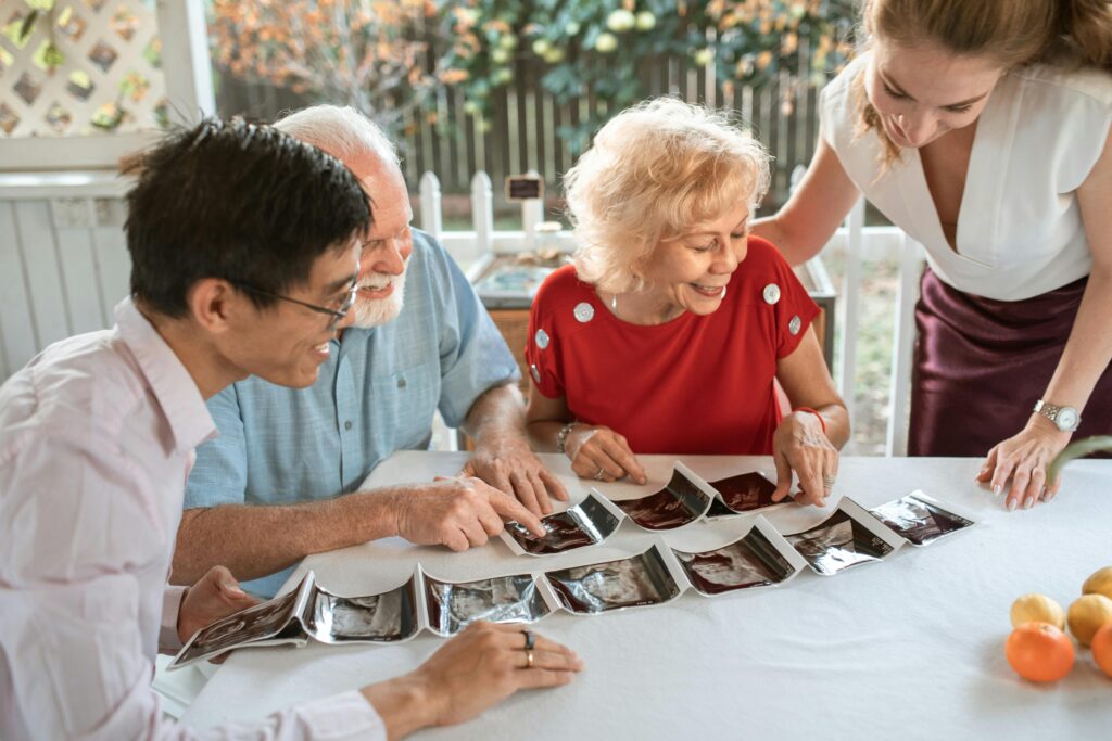 A happy family celebrating a pregnancy announcement with ultrasound photos.