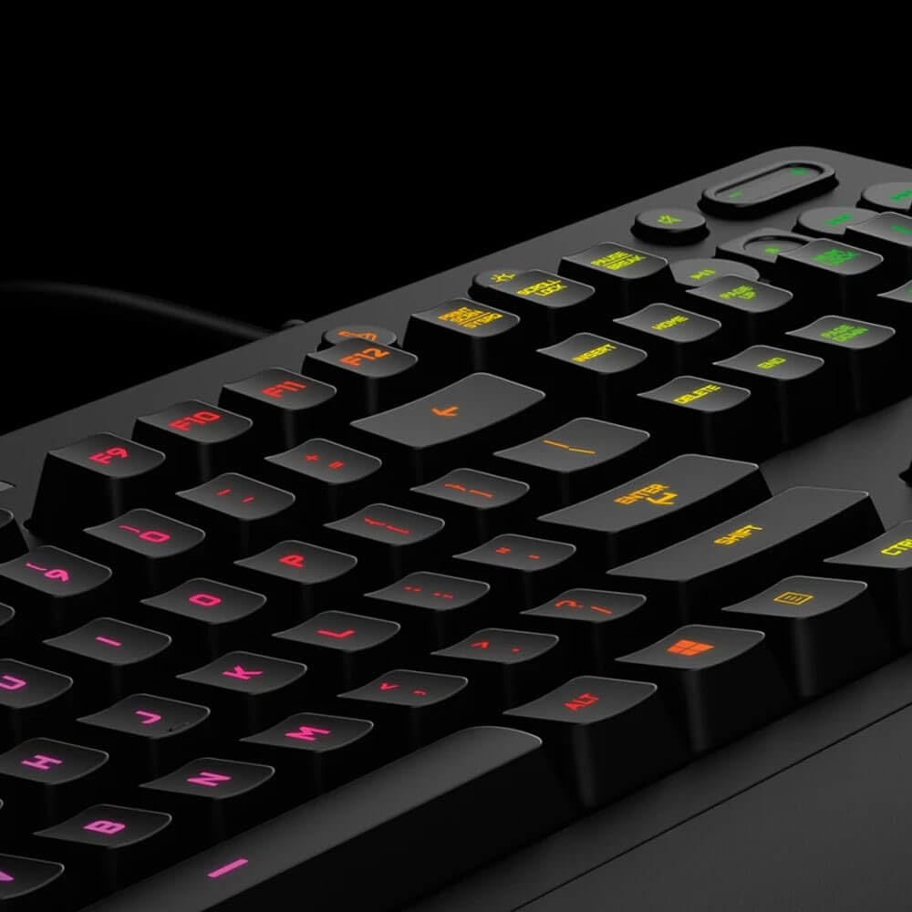 Close-up angled view of a black mechanical keyboard with RGB backlit keys glowing in red, yellow, and green against a dark background.